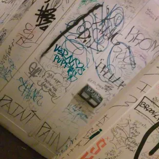 a bathroom with graffiti on the walls