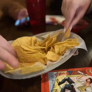 a plate of chips and a book