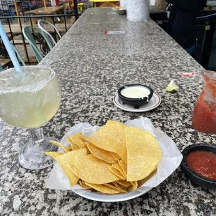 Chips, salsa, queso, and a large margarita on the rocks!