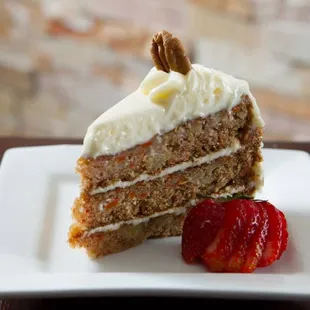 a piece of carrot cake and a strawberry
