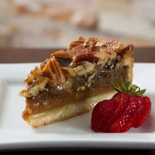 a piece of pie and a strawberry