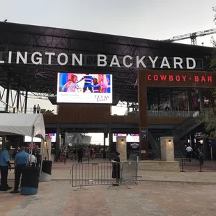 people standing in front of a baseball stadium