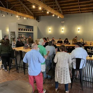 a group of people standing around a bar
