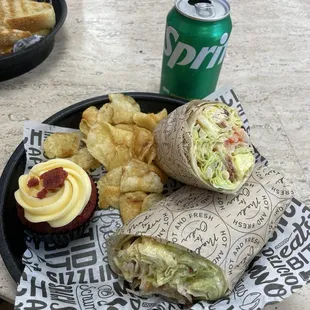 Chipotle BLT Wrap, chips, drink and cupcake.