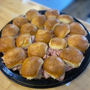 a plate of ham and cheese sliders