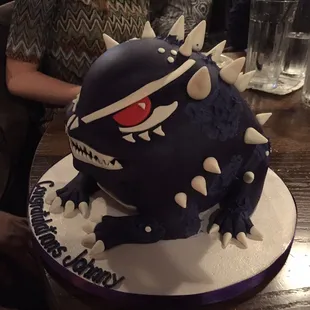 a blue cake with white icing and spiky spikes