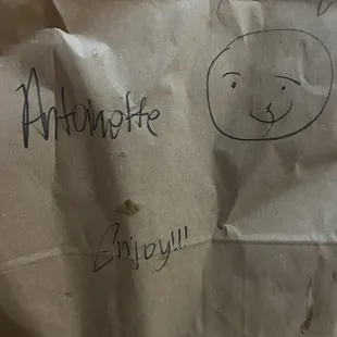 a paper bag with a drawing of a smiley face