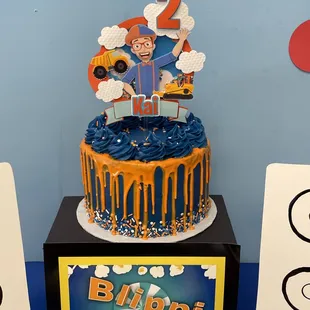 Blippi-inspired 8" drip cake; classic white flavor with mixed berry filling