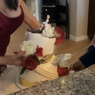 Taking off the top piece to save and serving bottom piece to our wedding guests