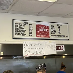 a menu above the counter of a restaurant