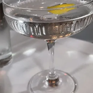 a glass of water with a lemon slice in it
