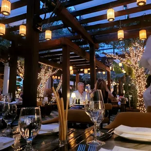 a dining area with a pergol roof