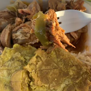 A bite of the stew chicken with peppers &amp; onions