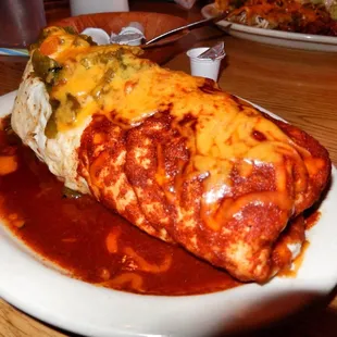 Ground beef breakfast burrito with red and green chile