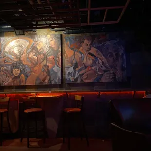a mural of women in a bar