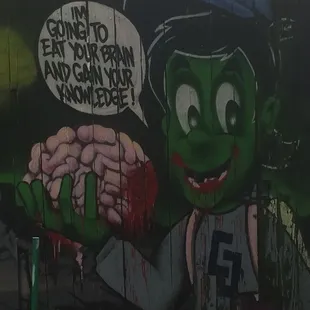 a graffiti of a zombie eating a brain