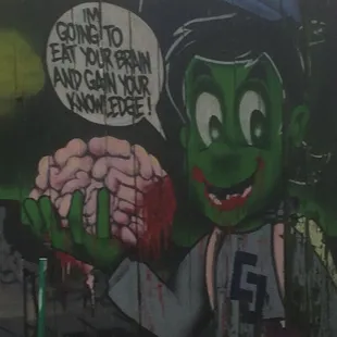 a graffiti of a man holding a brain