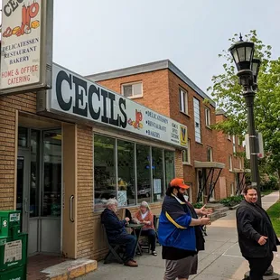 people sitting outside of a restaurant