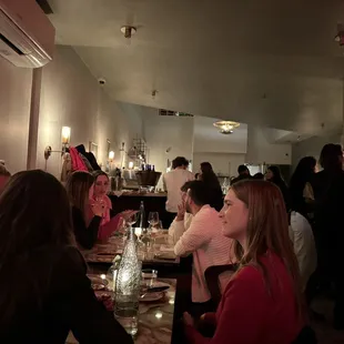 a group of people sitting at a table in a restaurant