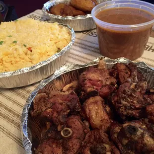 Family Meal #2 - fried chicken chunks (bone-in), yellow rice, beans, fried plantains. Not pictured: salad and 2-liter soda.