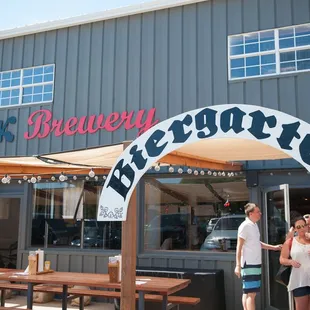 two people standing in front of a restaurant