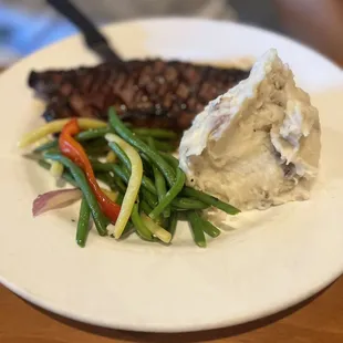 New York steak with mashed potatoes and vegetables