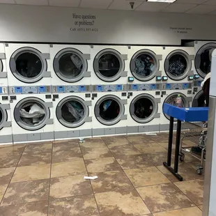 all dryers full, stuff on floor