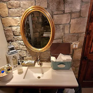 The sink and mirror in the restroom.