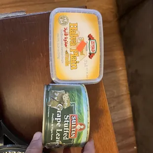 a person holding a can of canned food