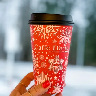 a hand holding a cup of coffee