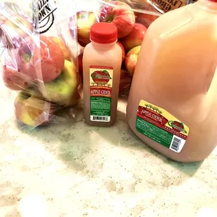 a bottle of apple juice and a jug of apple juice