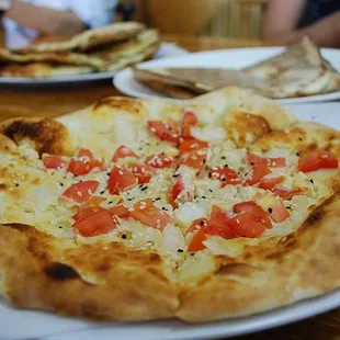 a pizza with tomatoes and cheese