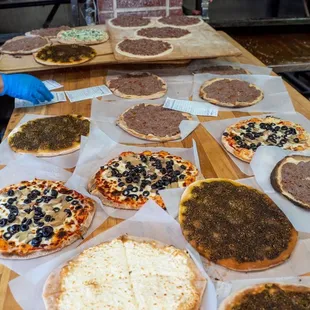 a variety of pizzas on a table