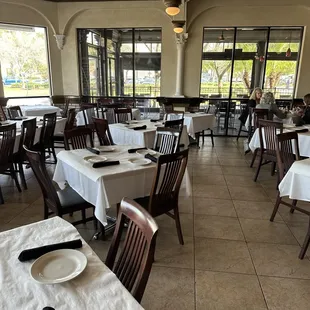 tables and chairs with white tablecloths