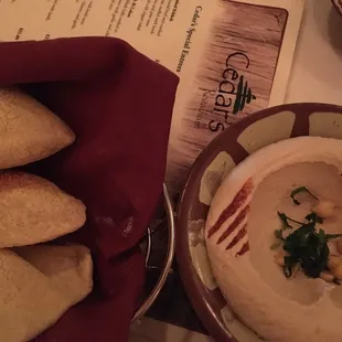 a bowl of hummusle and bread