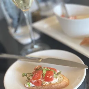 a plate of food and a glass of wine