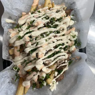 Beef or Chicken Shawarma Fries made with our housemade Tahini &amp; our spicy house sauce
