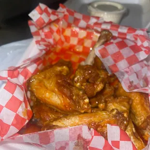 chicken wings wrapped in red and white checkered paper