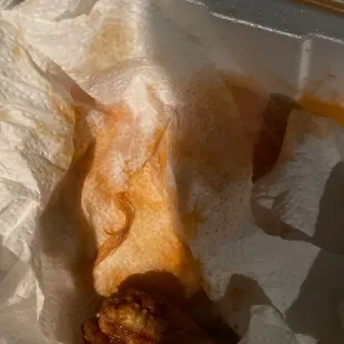 a fried chicken in a paper wrapper