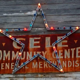 a rusty sign with a star on it