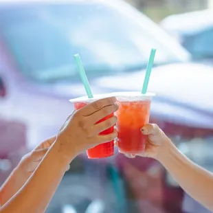 two women toasting with drinks