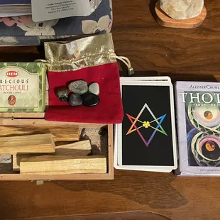 Palo santo sticks, droop cones, crystals, and THOT tarot card deck (78 cards)