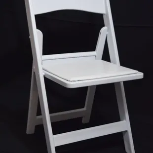 Resin padded white folding chair.