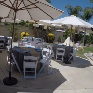 Market Umbrellas and White Padded Chairs