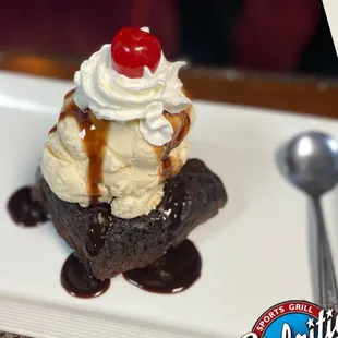 a chocolate sundae with whipped cream and a cherry on top