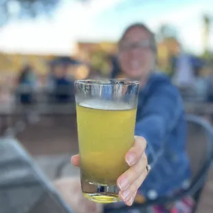 a woman holding a glass of beer