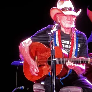 a man in a cowboy hat playing a guitar