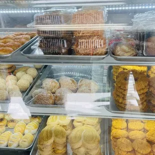 a variety of baked goods in a display case
