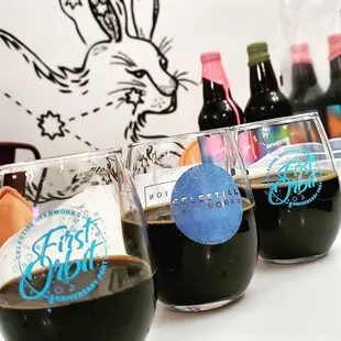 a row of glasses filled with different types of beer