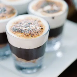 four glasses of coffee on a plate